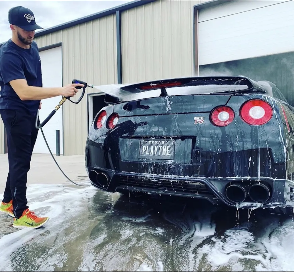 Mobile detailing in Calabasas — rinsing the rear of a black Nissan GT-R during a wash and seal