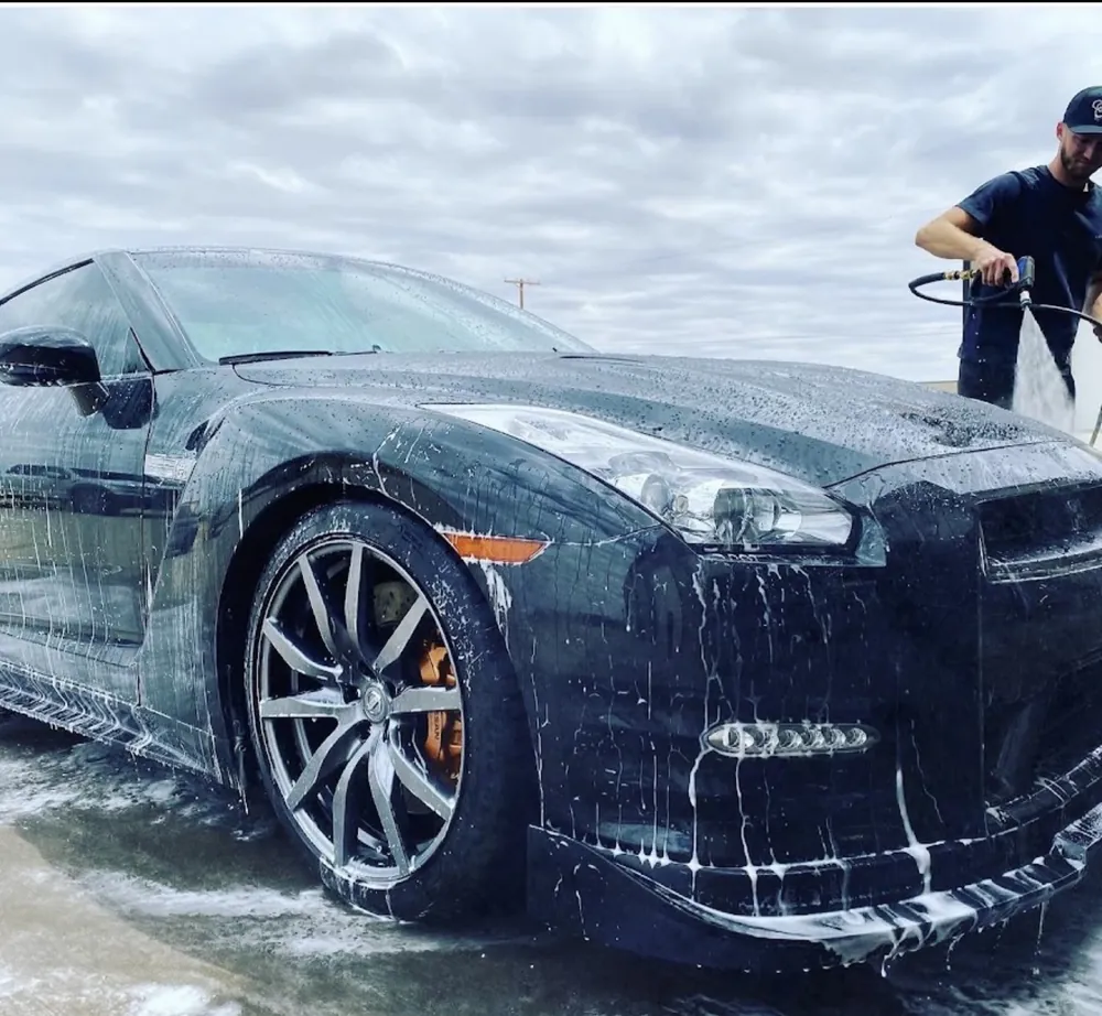 Mobile detailing in Calabasas — Landon foam-washing the front of a black Nissan GT-R
